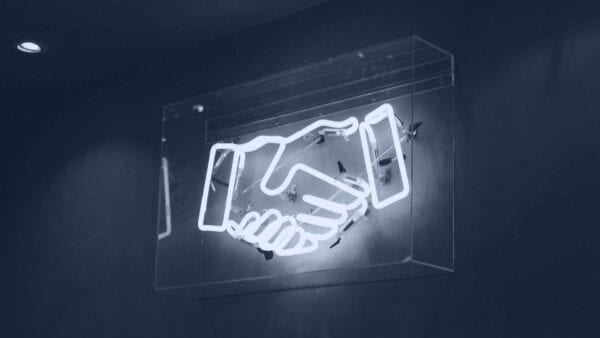 neon light of two hands shaking