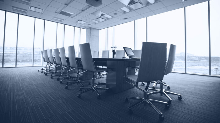 Conference room with tall glass window walls.